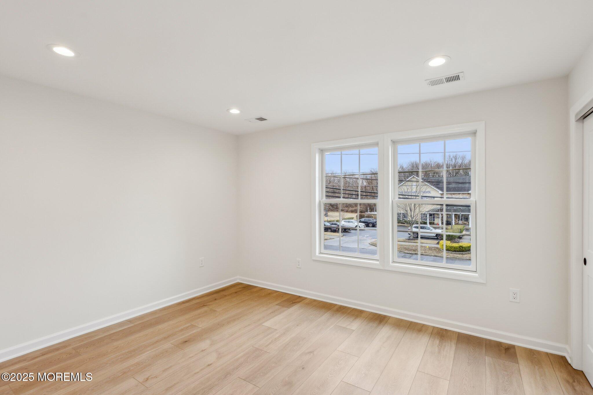 563 Holmdel Road Hazlet, NJ 07730 - Photo 23 of 50 wooden floor in an empty room with a window