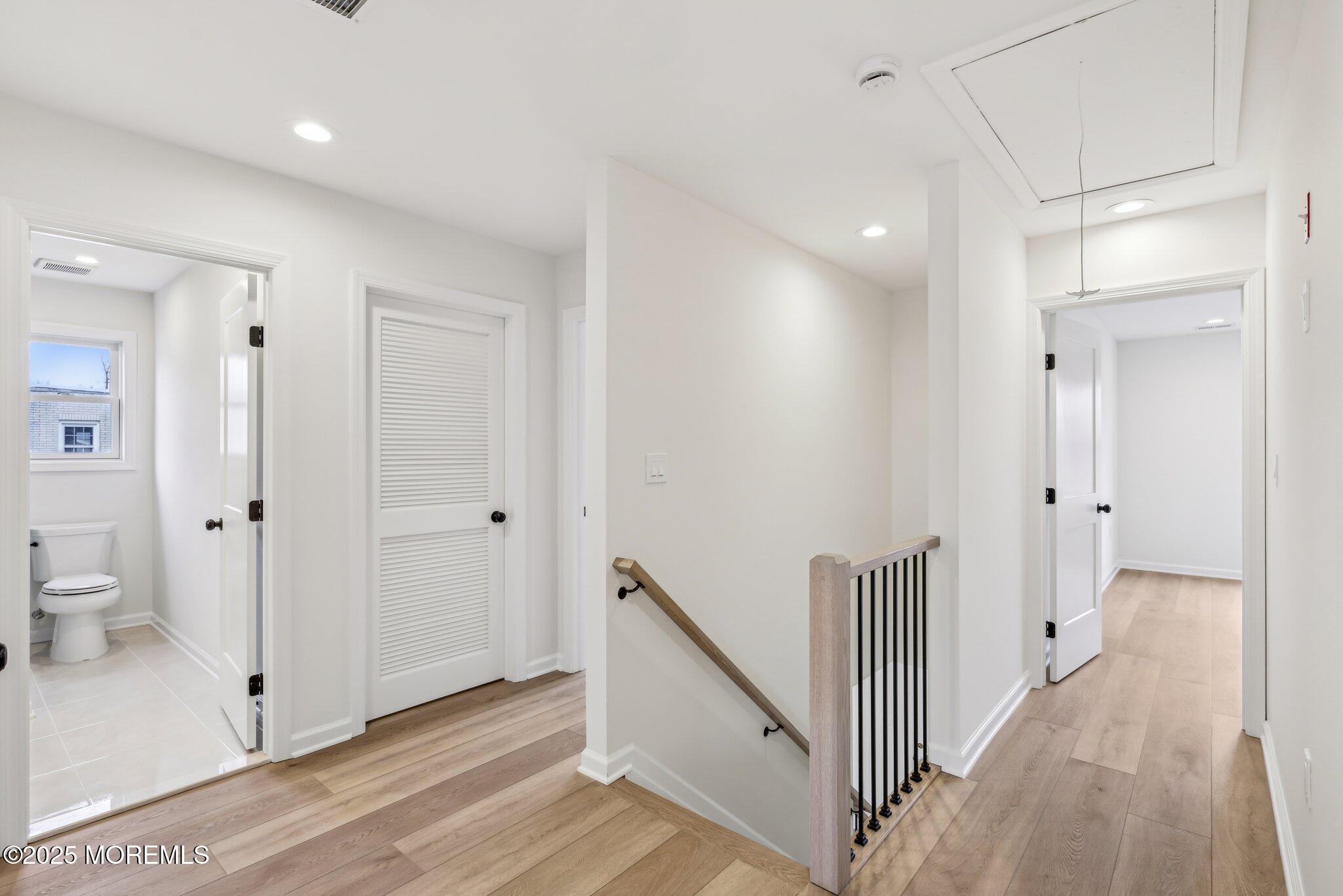 563 Holmdel Road Hazlet, NJ 07730 - Photo 32 of 50 a view of a hallway with bathroom and wooden floor