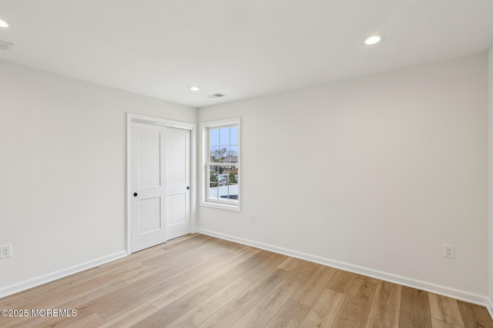 563 Holmdel Road Hazlet, NJ 07730 - Photo 35 of 50 a view of an empty room with wooden floor