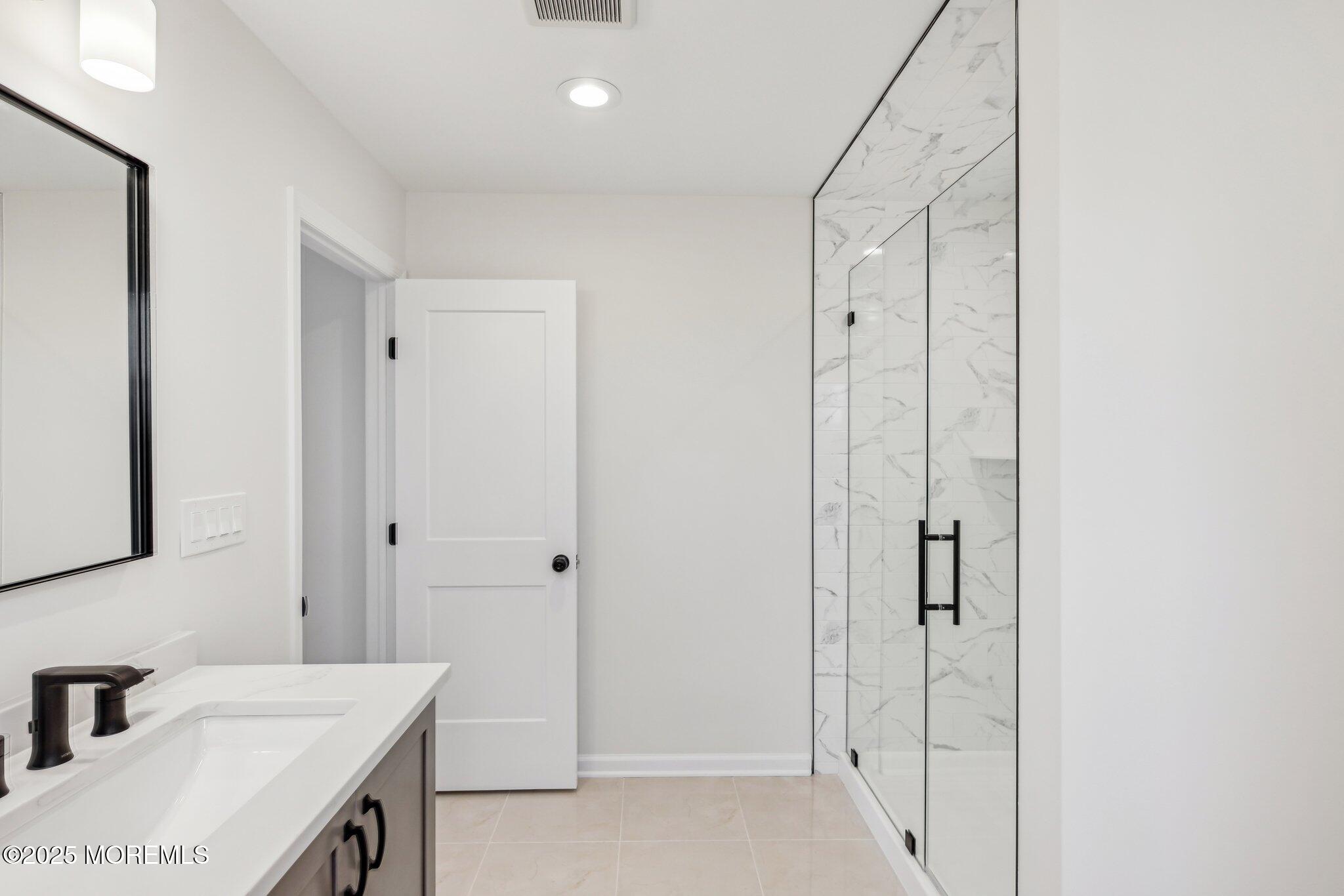 563 Holmdel Road Hazlet, NJ 07730 - Photo 39 of 50 a bathroom with a sink and a mirror