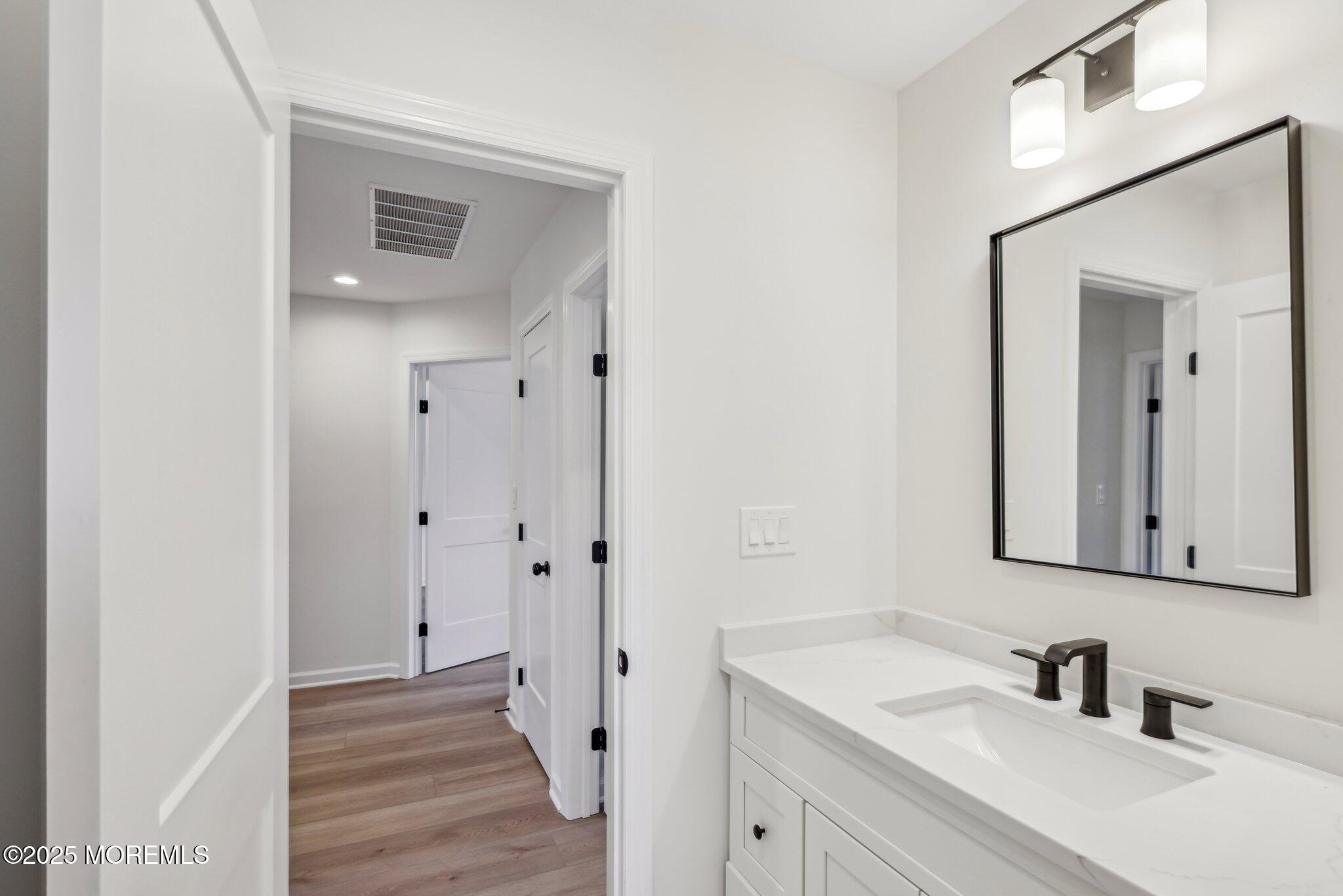 563 Holmdel Road Hazlet, NJ 07730 - Photo 45 of 50 a bathroom with a sink and a mirror