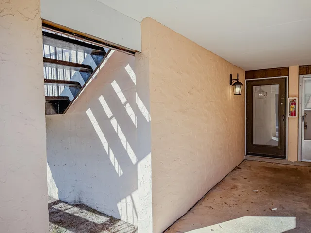 a view of staircase with white walls and a window