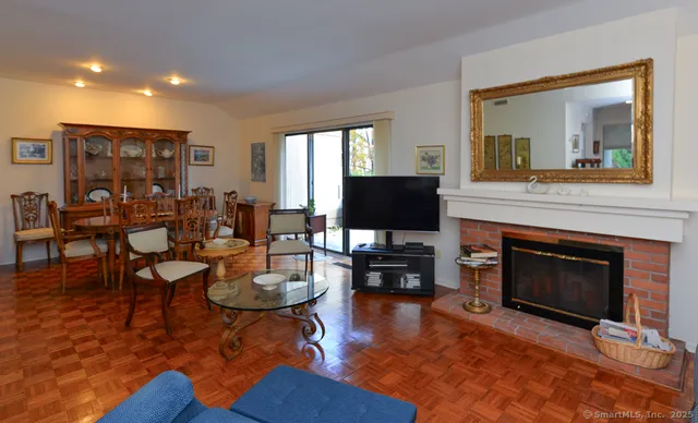 a living room with furniture a fireplace and a flat screen tv