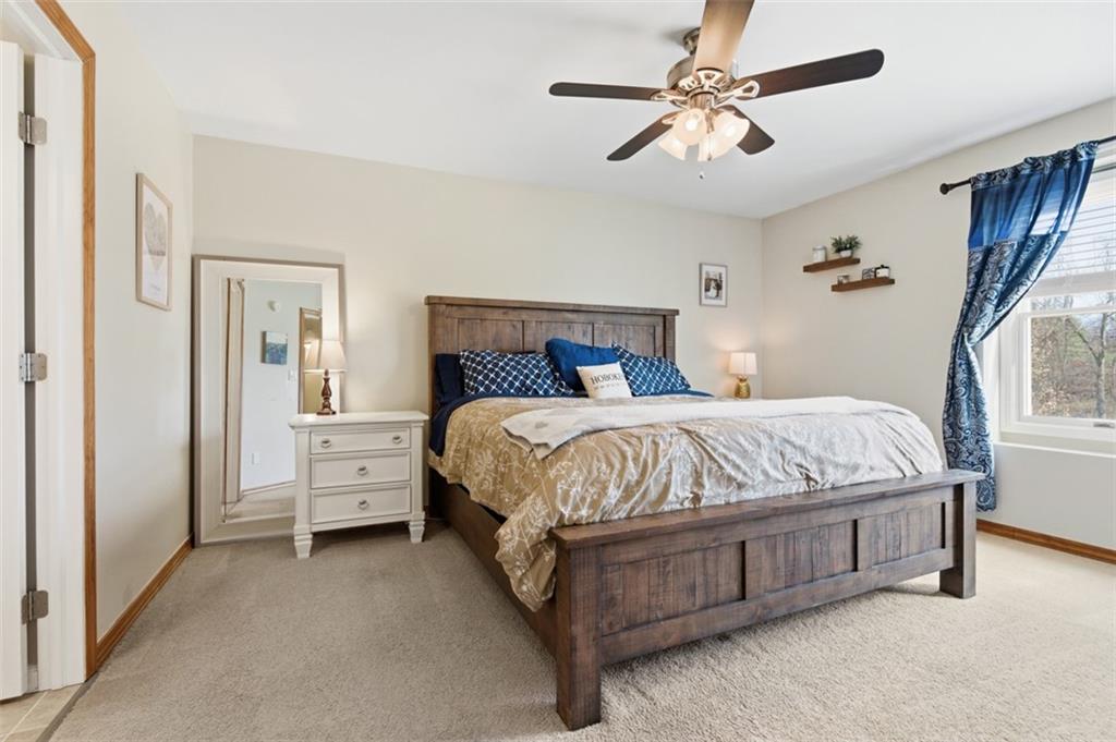 44 Rodgers Drive Coraopolis, PA 15108 - Photo 28 of 42 a spacious bedroom with a bed and a chandelier