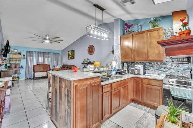 a kitchen with a sink stove and cabinets