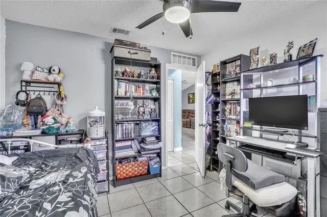 a view of a livingroom with workspace and a window