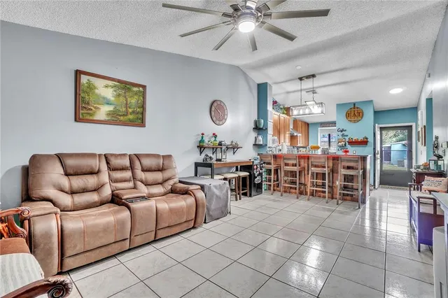 a living room with furniture a dining table and chairs