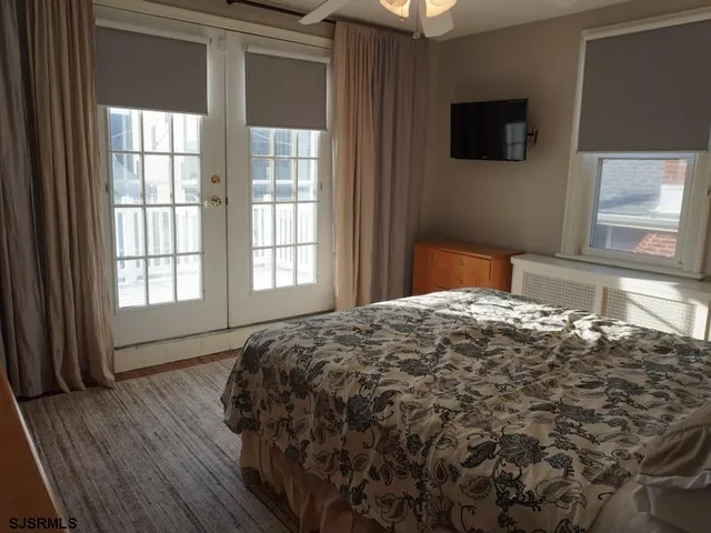 a bedroom with a bed and a television