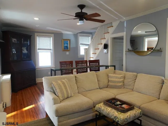 a living room with furniture and a wooden floor