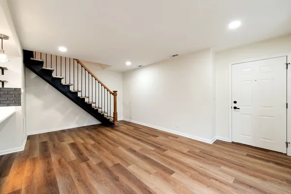 a view of an empty room with wooden floor