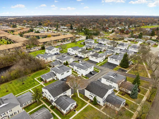 an aerial view of residential building with parking