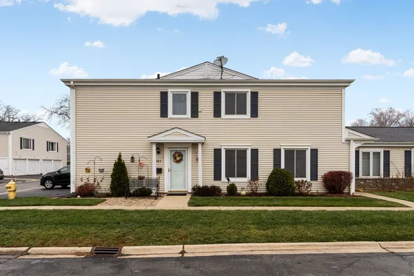 a front view of a house with a garden