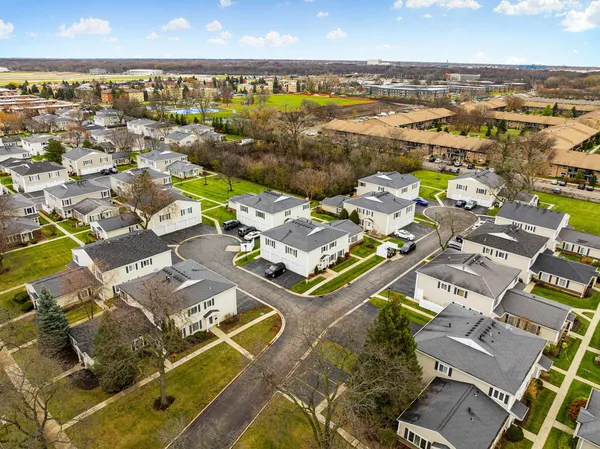 an aerial view of residential building with parking