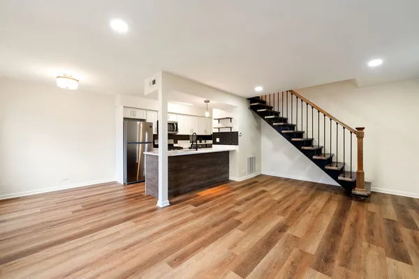 a view of kitchen with sink and refrigerator