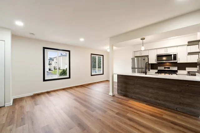 a view of kitchen with microwave and refrigerator
