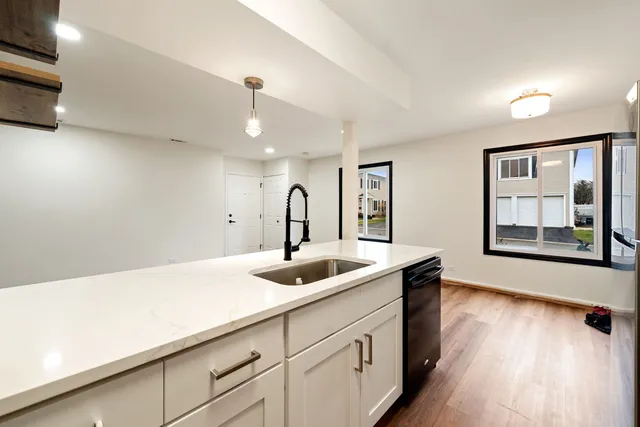 a kitchen with a sink and cabinets