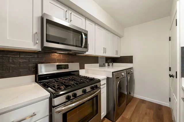 a kitchen with a stove and a microwave