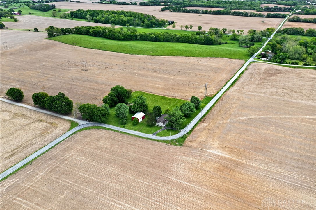 2470 Clark Run Road Xenia, OH 45385 - Photo 54 of 57 This aerial view showcases a quaint residence nestled amidst expansive fields and winding roads.