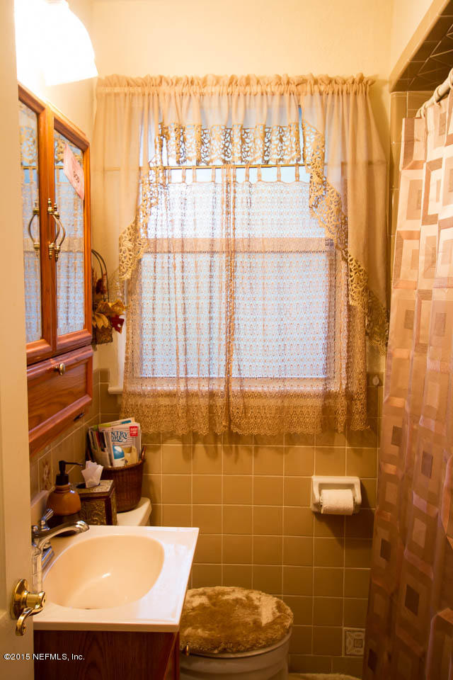 4656 Westfield Road Jacksonville, FL 32210 - Photo 18 of 54 a bathroom with a sink toilet and shower