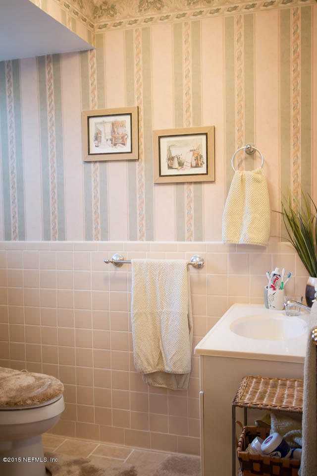 4656 Westfield Road Jacksonville, FL 32210 - Photo 28 of 54 a bathroom with a sink a toilet and a shower curtain