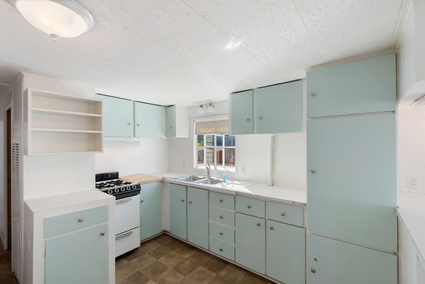 750 47th Avenue, Unit 53 Capitola, CA 95010 - Photo 12 of 39 a kitchen with cabinets stainless steel appliances and a window