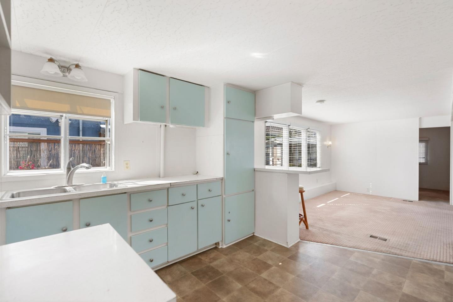 750 47th Avenue, Unit 53 Capitola, CA 95010 - Photo 13 of 39 a kitchen with a sink a window and cabinets