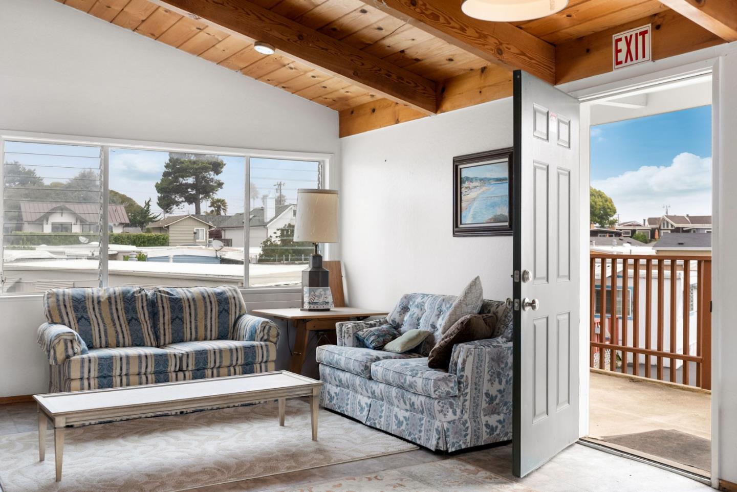 750 47th Avenue, Unit 53 Capitola, CA 95010 - Photo 37 of 39 a living room with furniture and a floor to ceiling window