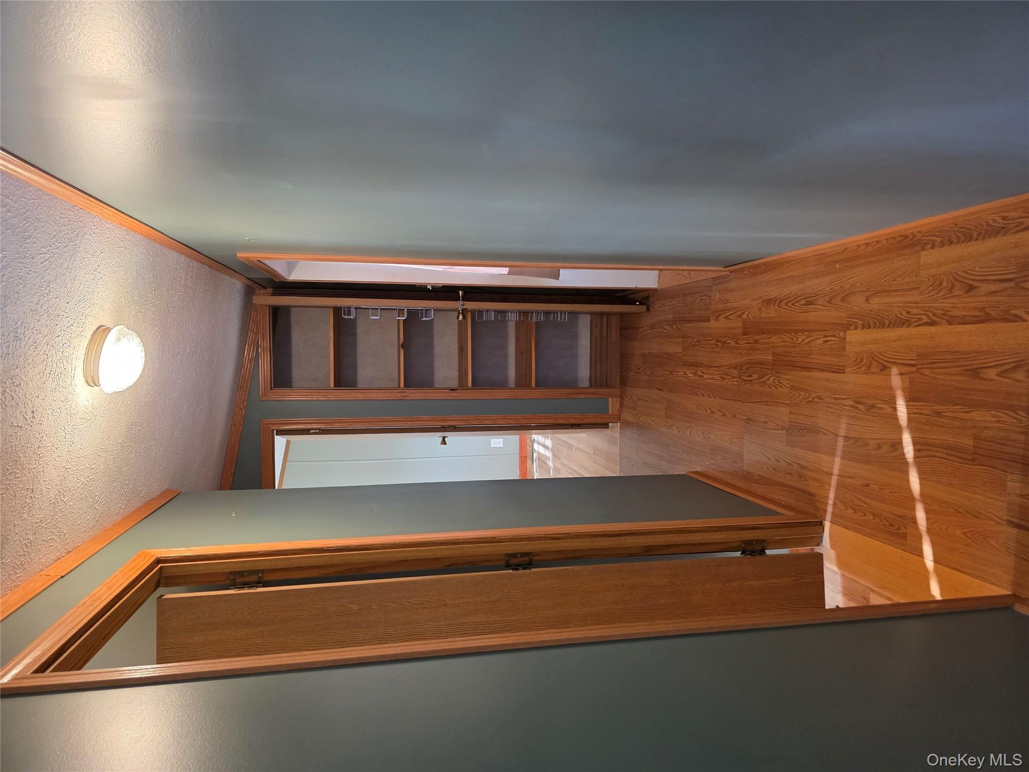 a view of a room with wooden floor and staircase