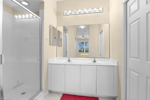 a bedroom with two beds and windows