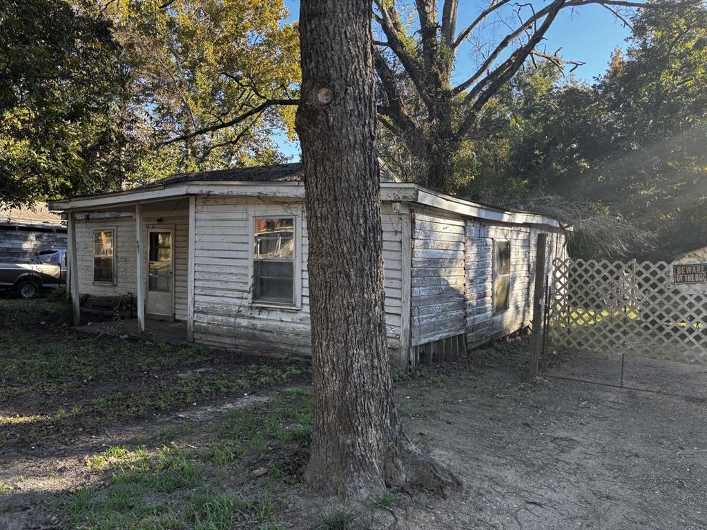 407 South Park Drive Springhill, LA 71075 - Photo 1 of 10 a view of backyard with large trees and wooden fence