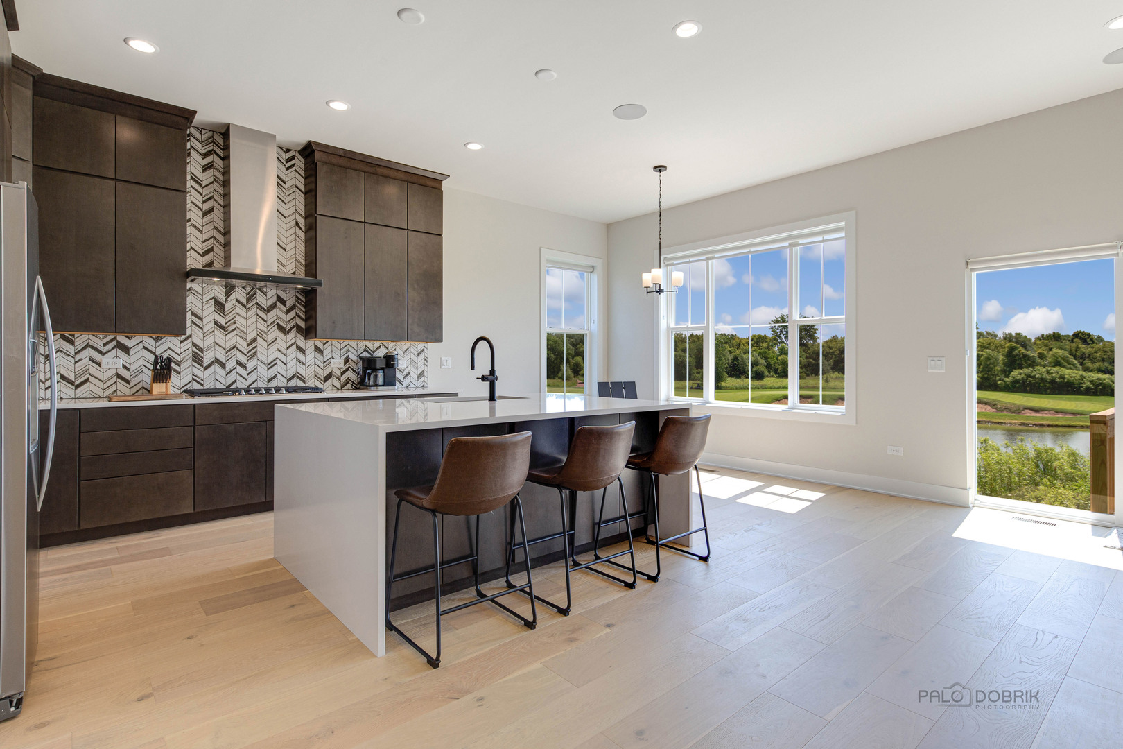 3531 South Riding Ridge Elgin, IL 60124 - Photo 12 of 36 a kitchen with stainless steel appliances kitchen island granite countertop a sink and a refrigerator