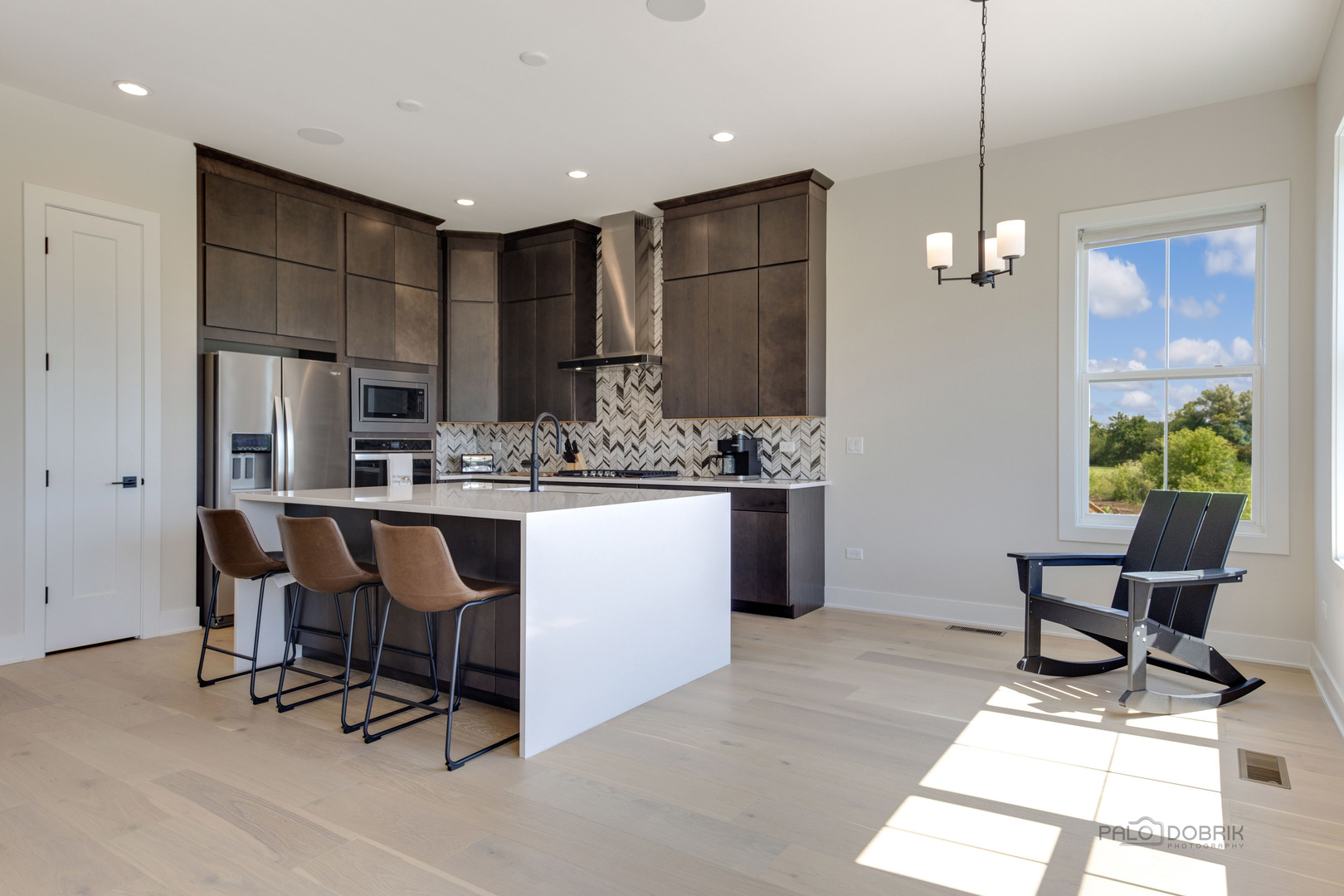 3531 South Riding Ridge Elgin, IL 60124 - Photo 13 of 36 a kitchen with stainless steel appliances kitchen island granite countertop a refrigerator a stove a sink dishwasher with a dining table and chairs