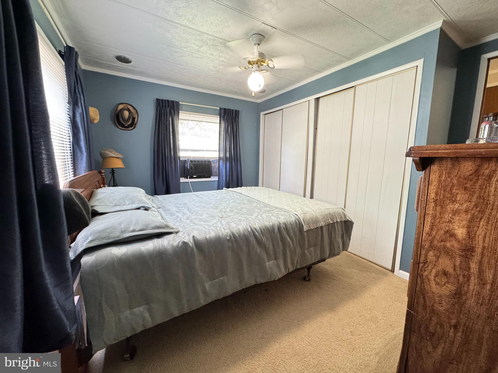 34118 Pinewood Circle, Unit 11080 Lewes, DE 19958 - Photo 14 of 22 a bedroom with a bed and a window