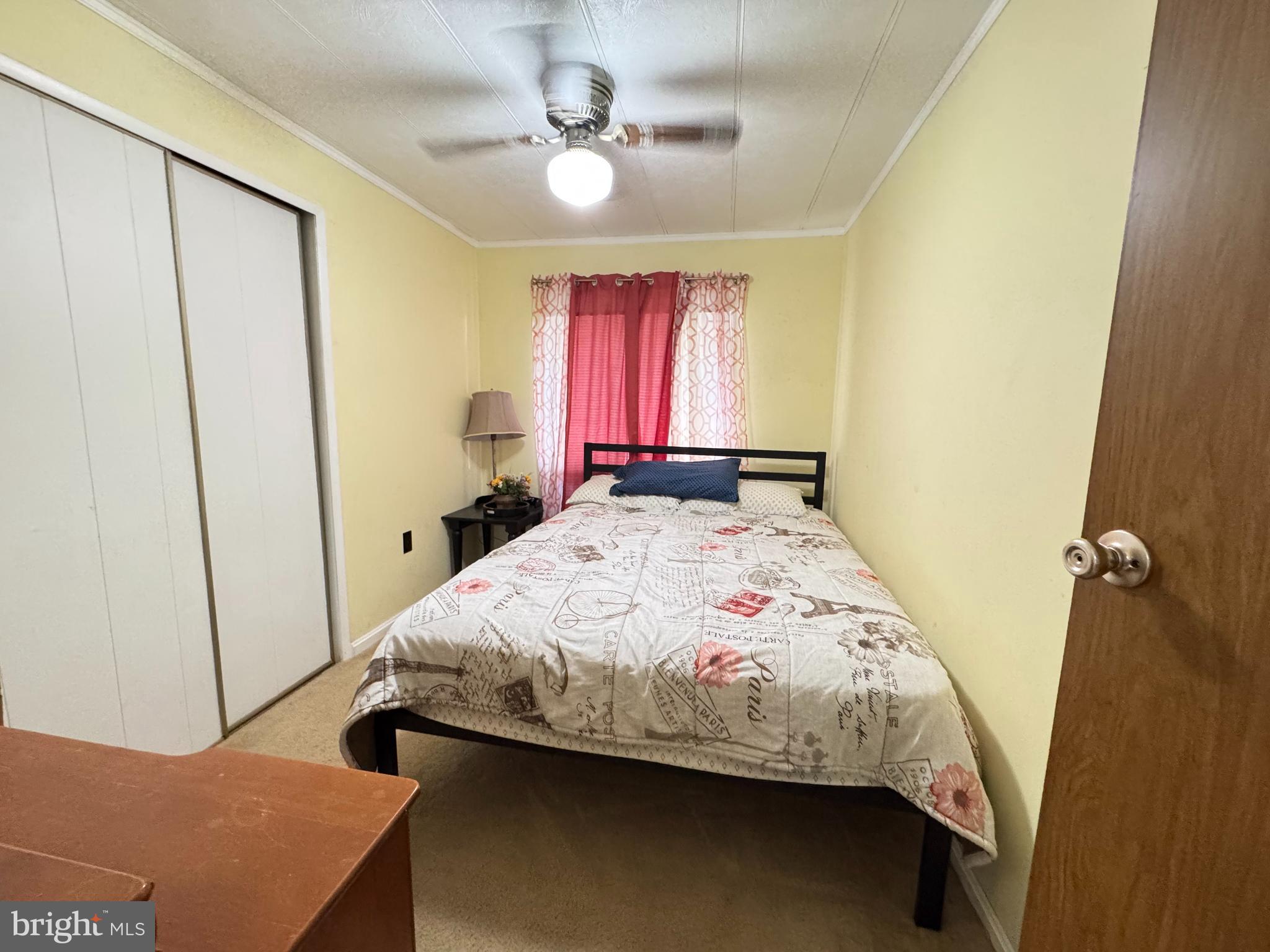 34118 Pinewood Circle, Unit 11080 Lewes, DE 19958 - Photo 17 of 22 a bedroom with a bed and a window