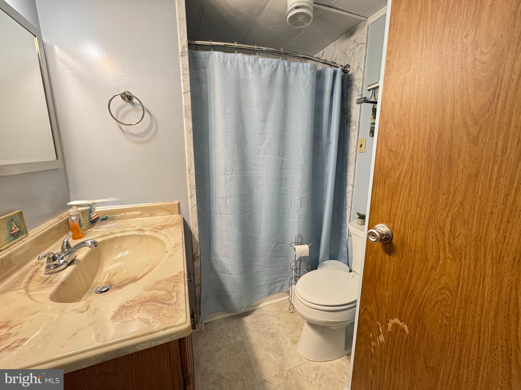 34118 Pinewood Circle, Unit 11080 Lewes, DE 19958 - Photo 18 of 22 a bathroom with a granite countertop sink toilet and shower
