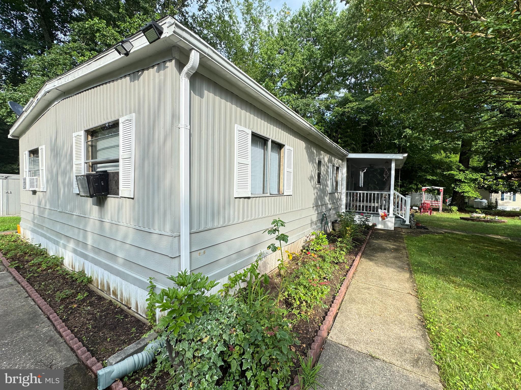 34118 Pinewood Circle, Unit 11080 Lewes, DE 19958 - Photo 2 of 22 a front view of a house with a yard