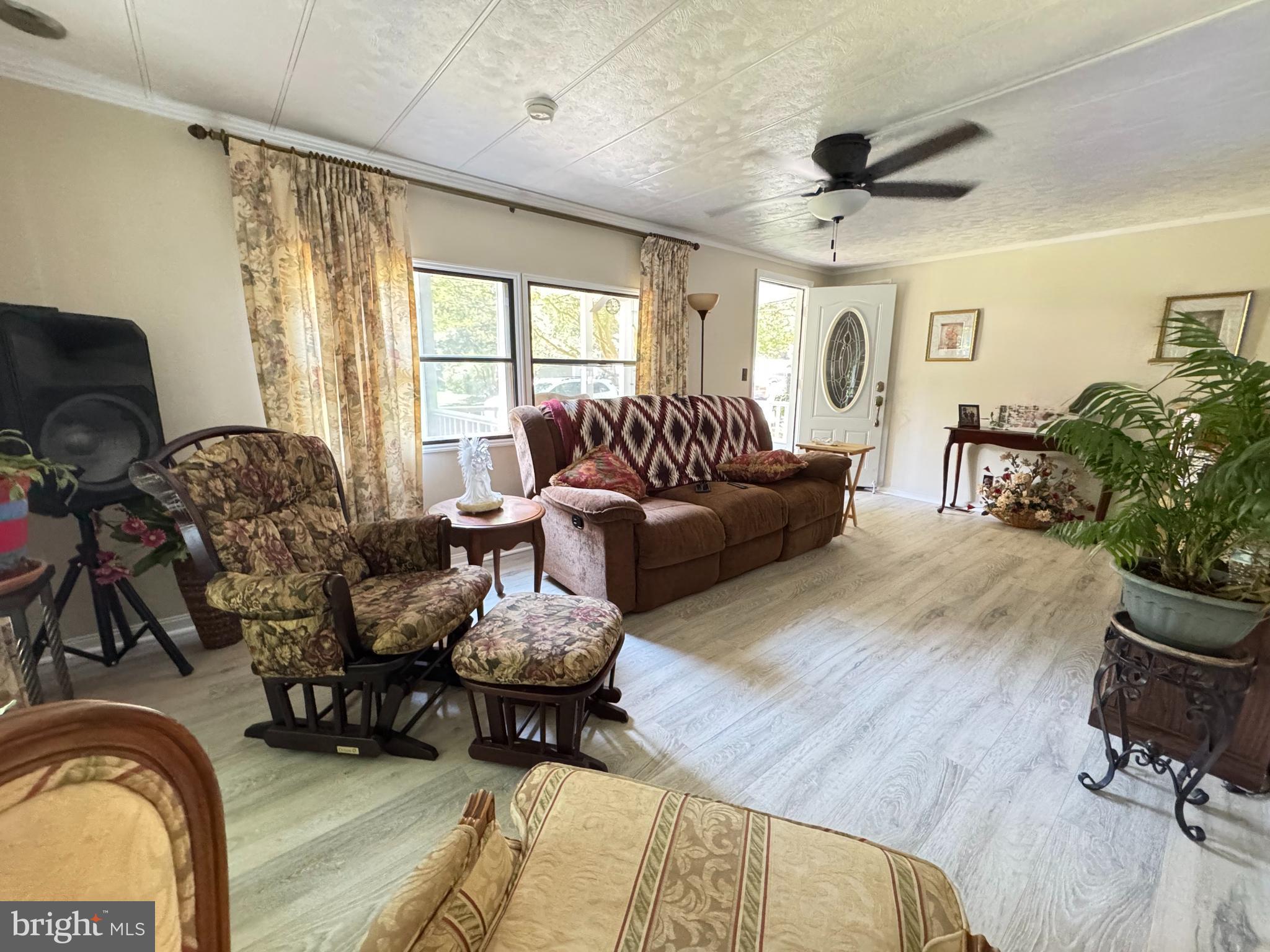 34118 Pinewood Circle, Unit 11080 Lewes, DE 19958 - Photo 7 of 22 a living room with furniture and wooden floor