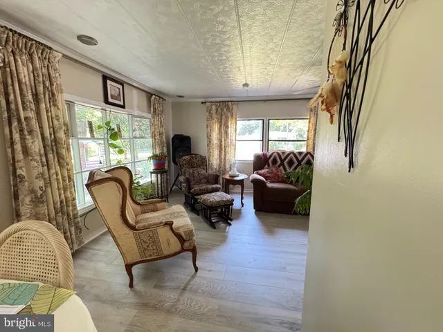a living room with furniture a fireplace and a large window