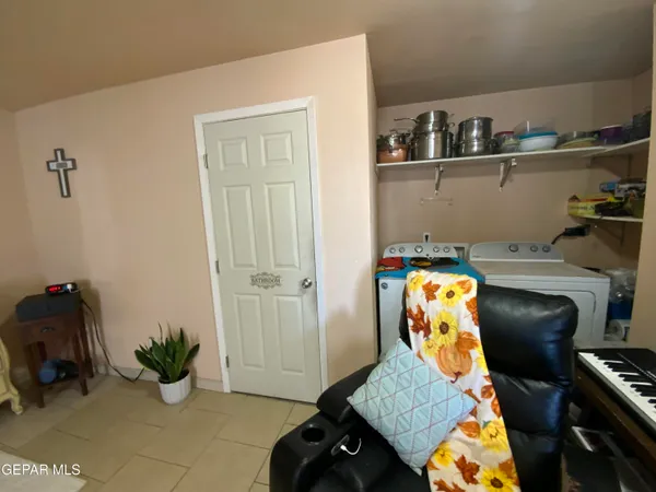 a living room with furniture a flat screen tv and a window