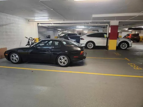 a view of parking garage with cars