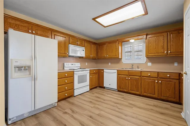 a kitchen with stainless steel appliances granite countertop a refrigerator sink and cabinets