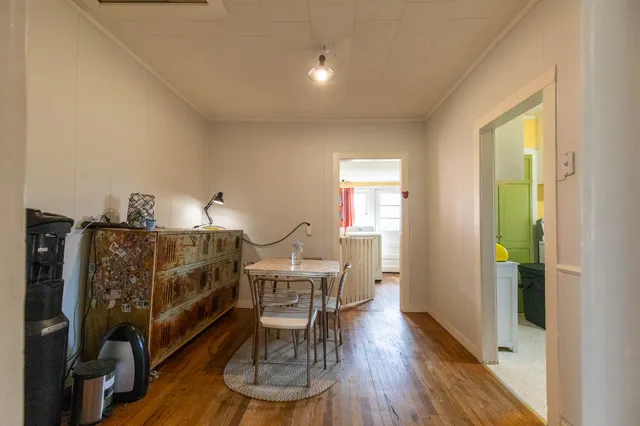 a view of storage and utility room with toys and wooden floor