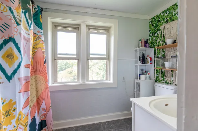 a living room with furniture fireplace and wooden floor