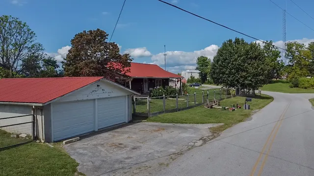 a view of a house with a yard and sitting area