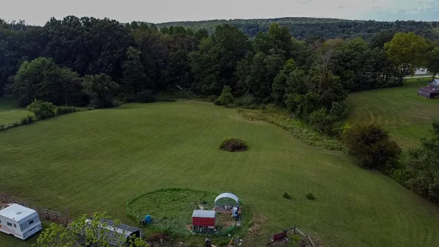 an aerial view of a house with a yard