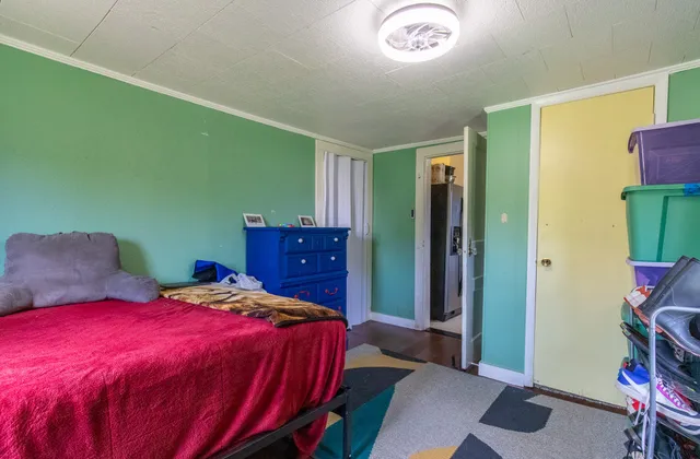 a kitchen with a sink cabinets and a wooden floor