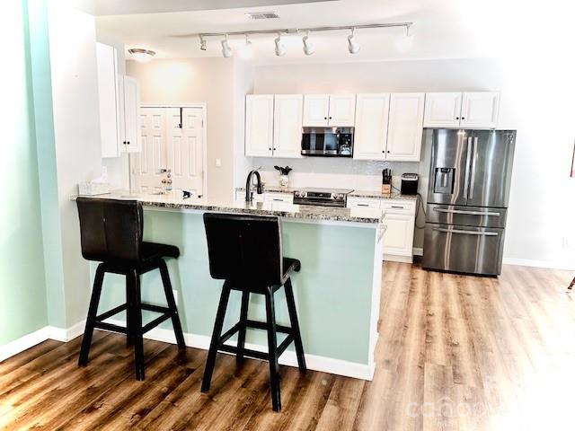 8006 Fine Robe Drive Indian Trail, NC 28079 - Photo 11 of 25 a kitchen with wooden cabinets and refrigerator