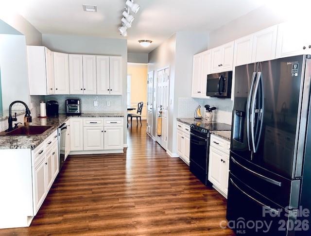 8006 Fine Robe Drive Indian Trail, NC 28079 - Photo 13 of 25 a kitchen with stainless steel appliances a refrigerator sink and cabinets