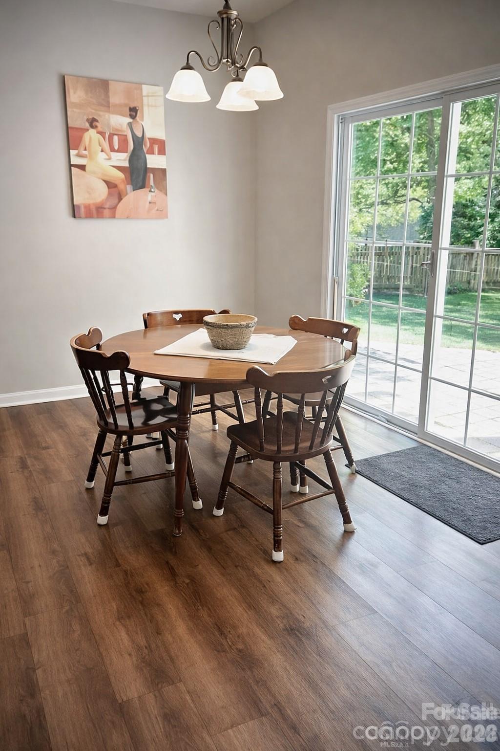 8006 Fine Robe Drive Indian Trail, NC 28079 - Photo 14 of 25 a view of a dining room with furniture window and wooden floor