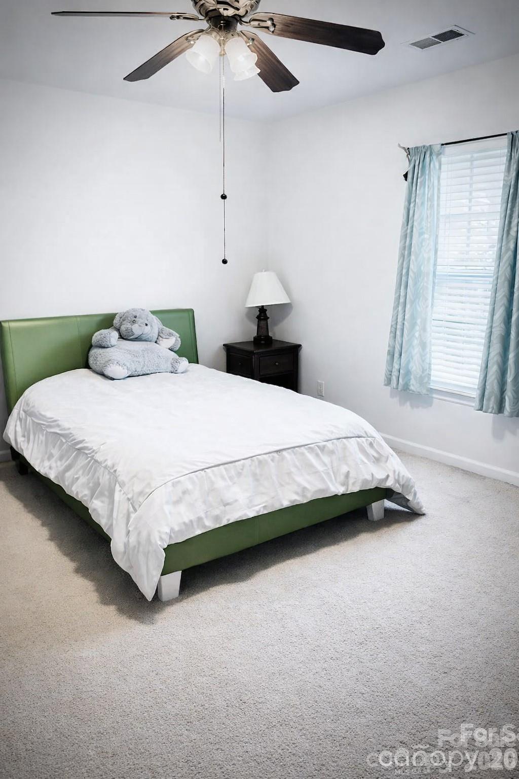 8006 Fine Robe Drive Indian Trail, NC 28079 - Photo 17 of 25 a bedroom with a bed chandelier and a window